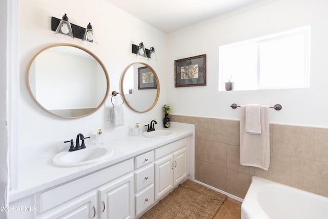 1330 E Monte Vista Rd, Phoenix, AZ 85006 - bathroom featuring a bath, tile walls, double vanity, and tile patterned flooring