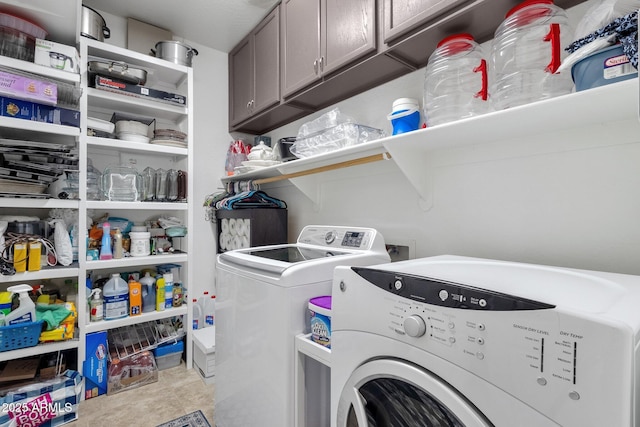 washroom featuring cabinets and separate washer and dryer