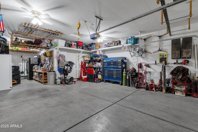 garage featuring a garage door opener, a workshop area, and ceiling fan