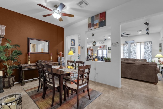 tiled dining area featuring ceiling fan