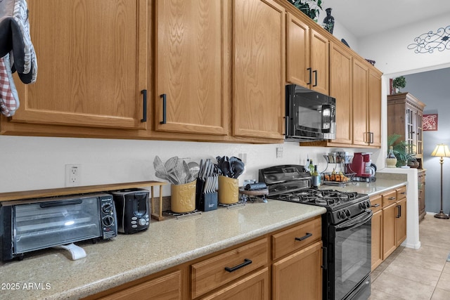 kitchen featuring light tile patterned floors and black appliances