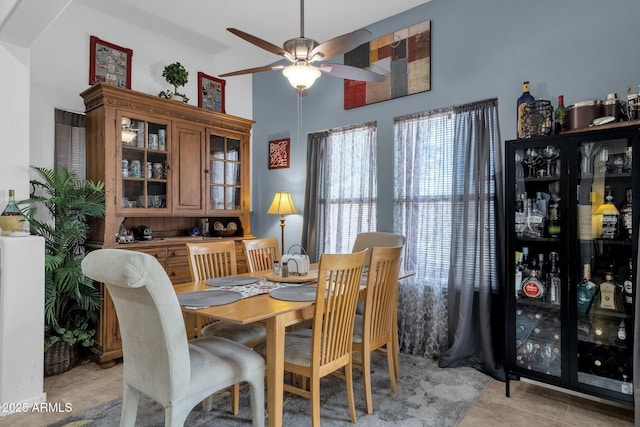 dining space featuring light tile patterned floors and ceiling fan