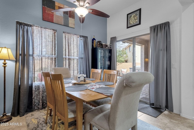 tiled dining room featuring ceiling fan