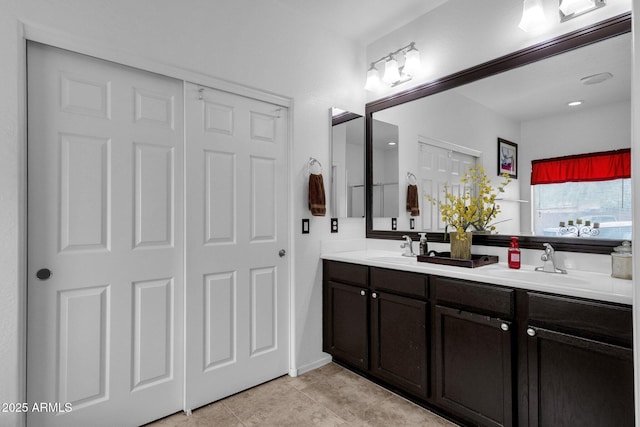 bathroom with tile patterned flooring and vanity