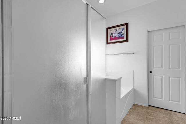 bathroom featuring shower with separate bathtub and tile patterned flooring