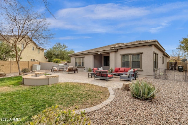 rear view of house with a patio and an outdoor living space with a fire pit