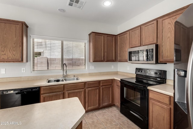 18719 E Pelican Ct, Queen Creek, AZ 85142 - kitchen featuring black appliances, a sink, light tile patterned floors, light countertops, and brown cabinetry