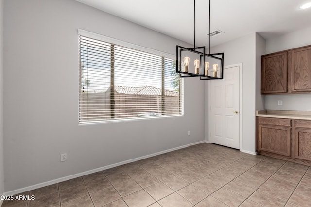 18719 E Pelican Ct, Queen Creek, AZ 85142 - unfurnished dining area with light tile patterned floors, a chandelier, and baseboards