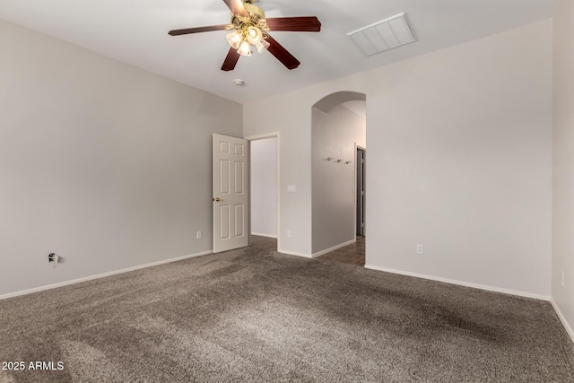 18719 E Pelican Ct, Queen Creek, AZ 85142 - empty room featuring arched walkways, dark colored carpet, ceiling fan, and baseboards
