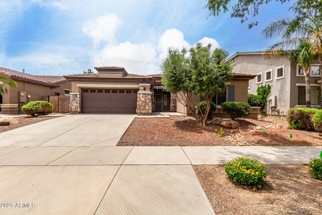 18719 E Pelican Ct, Queen Creek, AZ 85142 - view of front of home featuring an attached garage, concrete driveway, stucco siding, stone siding, and a tile roof