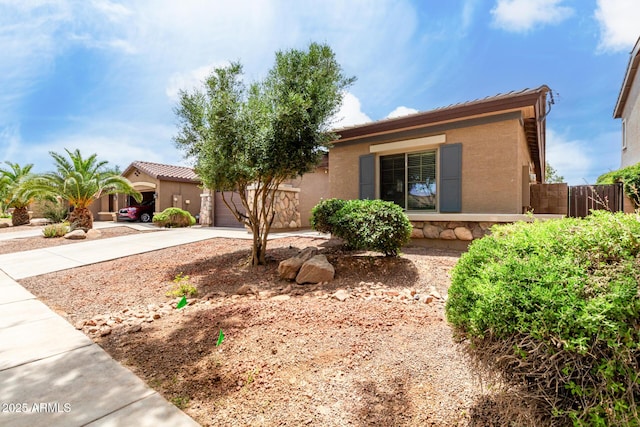 18719 E Pelican Ct, Queen Creek, AZ 85142 - view of front facade featuring concrete driveway, stone siding, a garage, and stucco siding