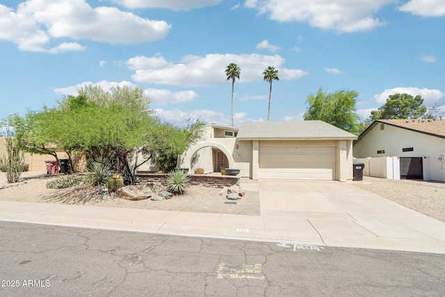 7734 E Rose Ln, Scottsdale, AZ 85250 - view of front of property featuring a garage, stucco siding, and concrete driveway