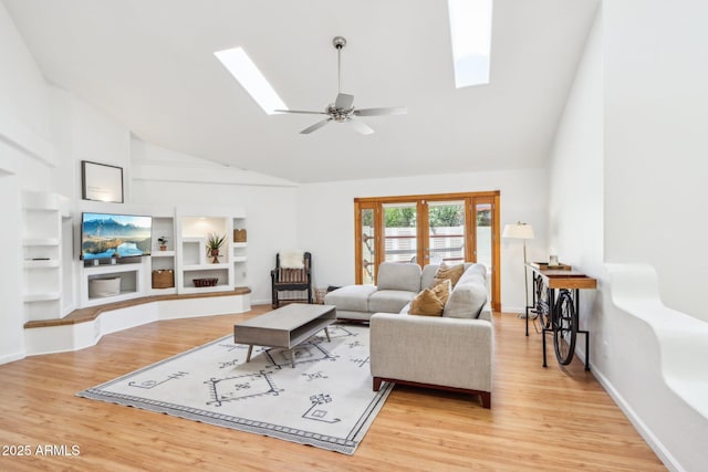 7734 E Rose Ln, Scottsdale, AZ 85250 - living area with high vaulted ceiling, built in features, wood finished floors, and a skylight