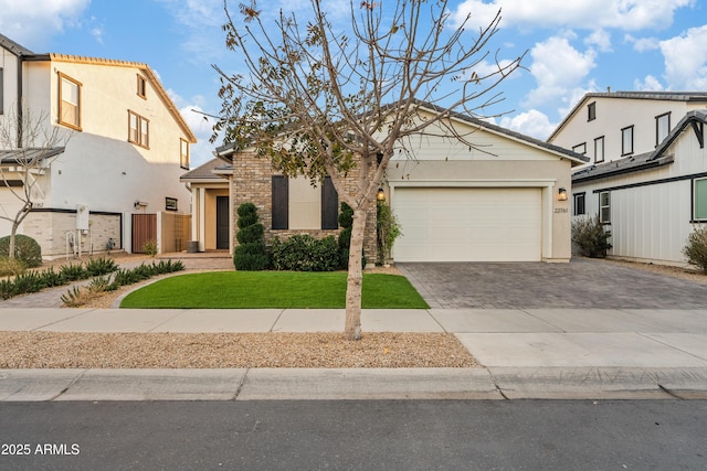 view of front of house featuring a garage and a front yard