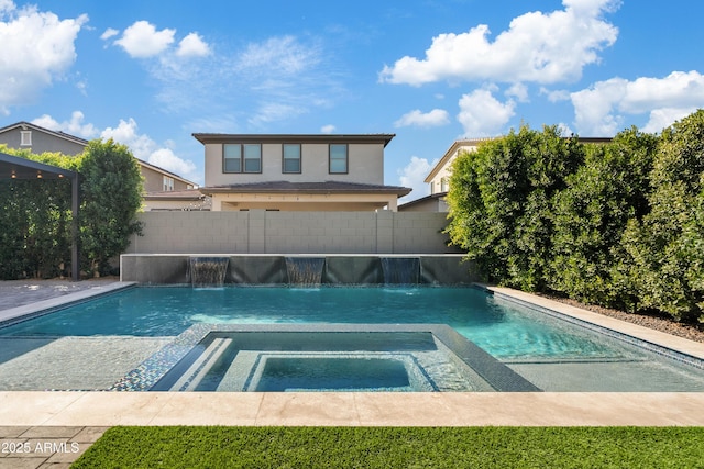 view of pool with pool water feature and an in ground hot tub