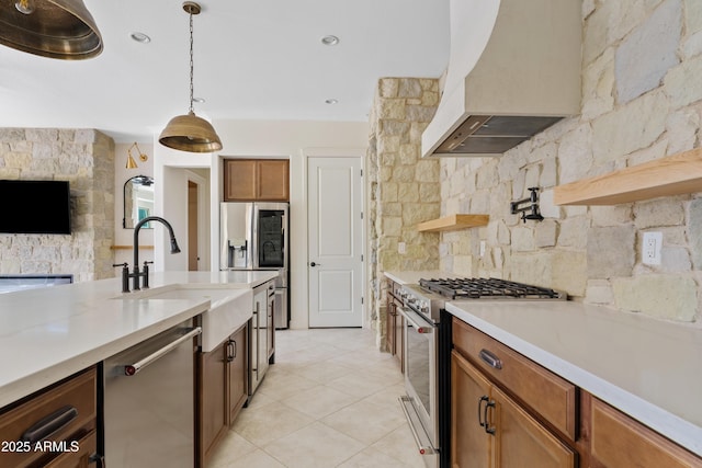 kitchen with premium range hood, appliances with stainless steel finishes, decorative light fixtures, sink, and light tile patterned floors