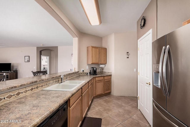 kitchen with light countertops, black dishwasher, light tile patterned floors, stainless steel refrigerator with ice dispenser, and a sink