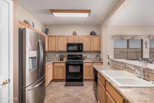 kitchen with black appliances, light brown cabinets, a sink, light tile patterned flooring, and light countertops