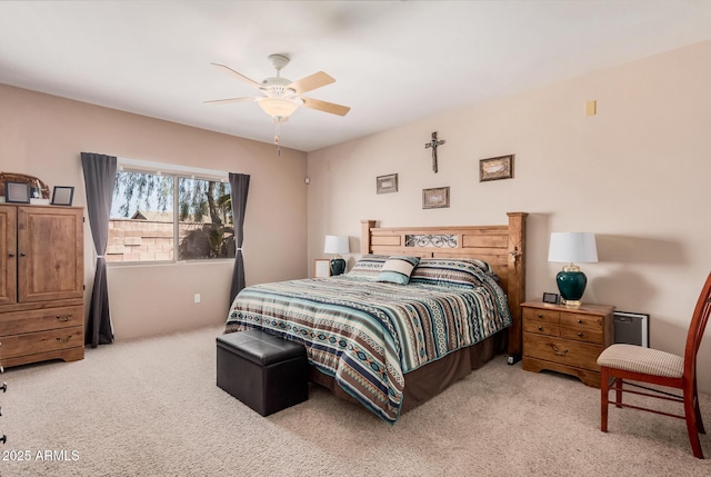 bedroom with a ceiling fan and carpet