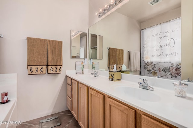 bathroom with tile patterned flooring, visible vents, double vanity, and a sink