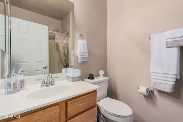 bathroom with vanity, a shower with shower curtain, and toilet