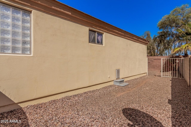 view of home's exterior featuring fence and stucco siding