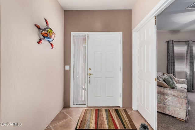 entryway featuring light tile patterned floors and visible vents