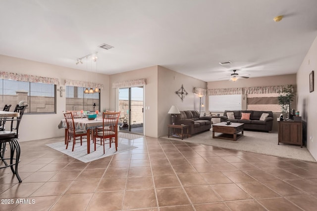 tiled dining room with visible vents and a ceiling fan