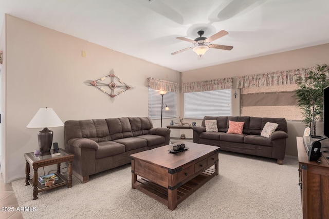 living area featuring light colored carpet and ceiling fan