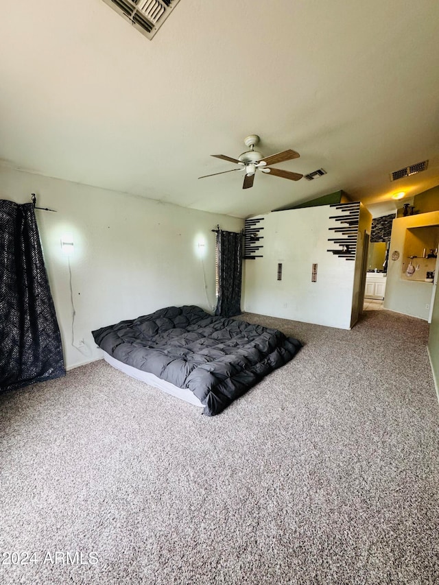 bedroom with carpet floors, vaulted ceiling, and ceiling fan