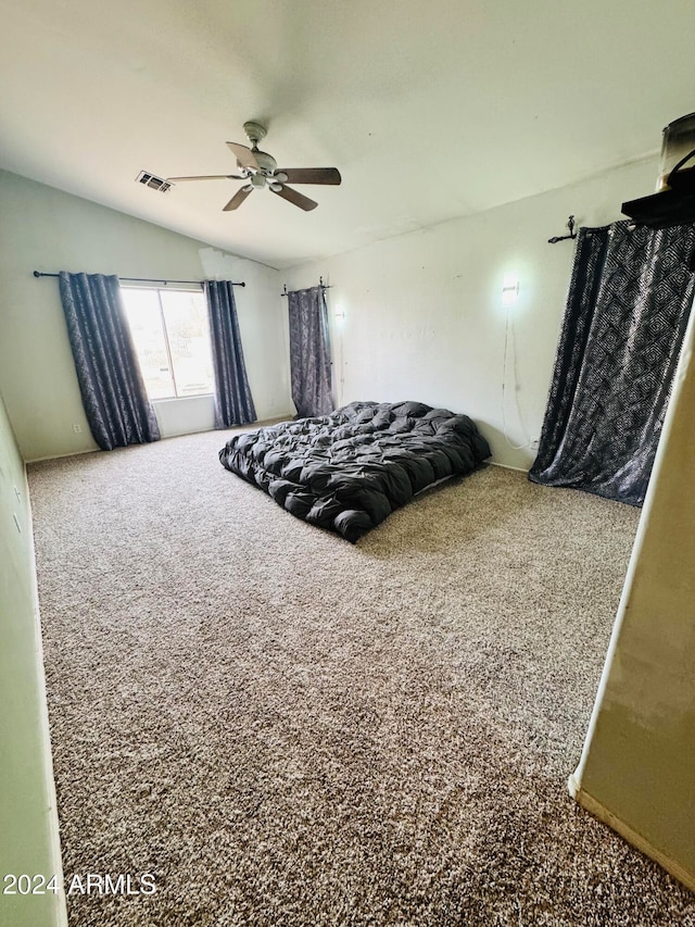 bedroom featuring ceiling fan, carpet, and vaulted ceiling