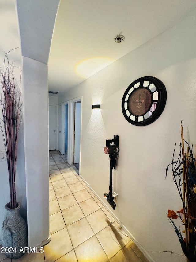 hall featuring light tile patterned flooring