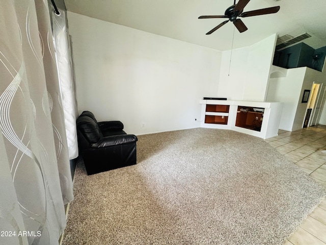 carpeted living room with ceiling fan