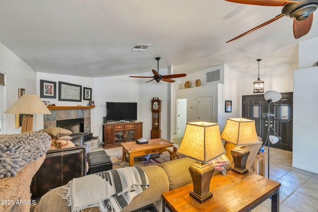 22201 E Vallejo St, Queen Creek, AZ 85142 - living area featuring ceiling fan, light tile patterned flooring, a tiled fireplace, and vaulted ceiling