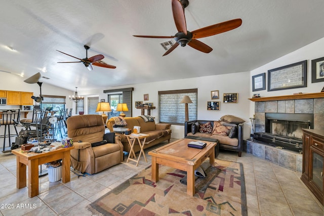 22201 E Vallejo St, Queen Creek, AZ 85142 - living area featuring lofted ceiling, ceiling fan, light tile patterned floors, a fireplace, and a textured ceiling