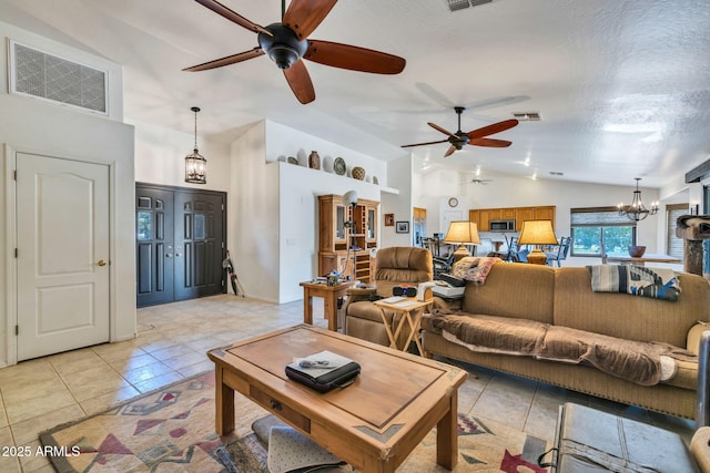 22201 E Vallejo St, Queen Creek, AZ 85142 - living area with a ceiling fan, light tile patterned floors, high vaulted ceiling, and a chandelier