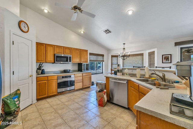 22201 E Vallejo St, Queen Creek, AZ 85142 - kitchen featuring stainless steel appliances, vaulted ceiling, light countertops, ceiling fan, and a chandelier