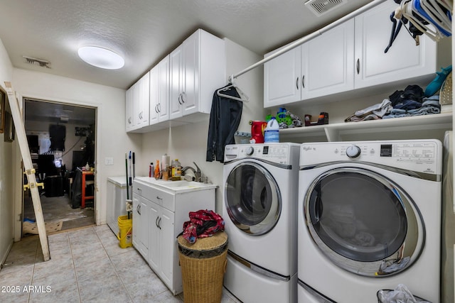 22201 E Vallejo St, Queen Creek, AZ 85142 - laundry room featuring washer and dryer, cabinet space, and a textured ceiling