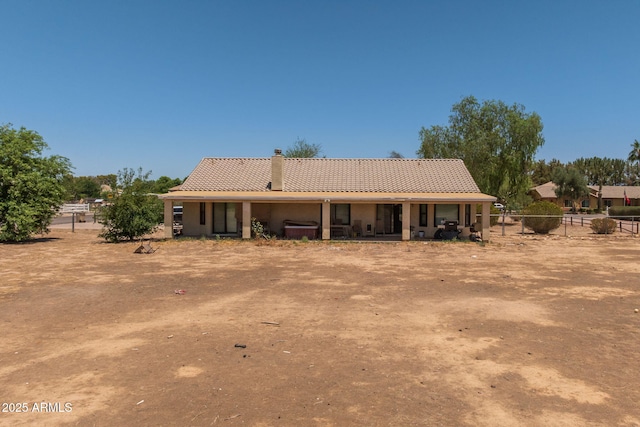 22201 E Vallejo St, Queen Creek, AZ 85142 - rear view of house with a tile roof, a chimney, and stucco siding