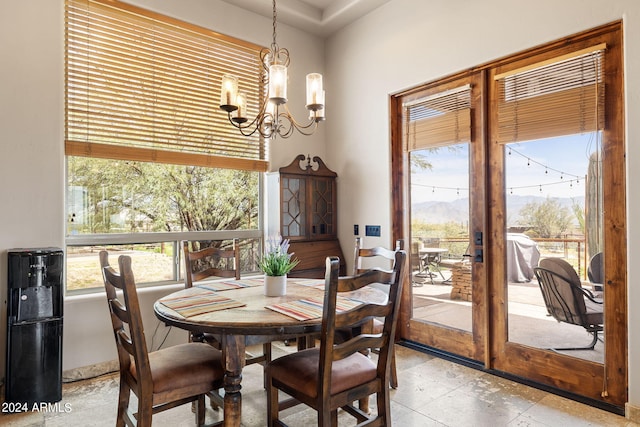 dining space featuring a notable chandelier and a mountain view