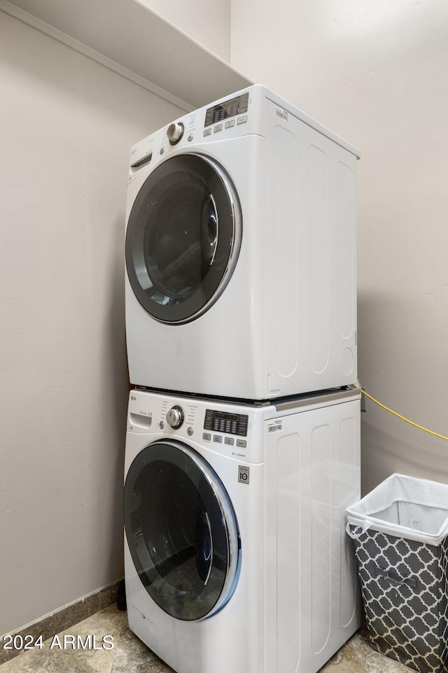 laundry room featuring stacked washer and clothes dryer