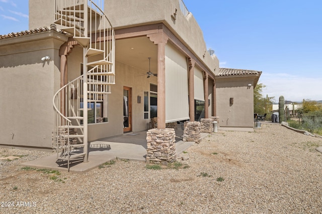 rear view of house with ceiling fan and a patio area