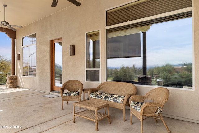 sunroom / solarium featuring ceiling fan