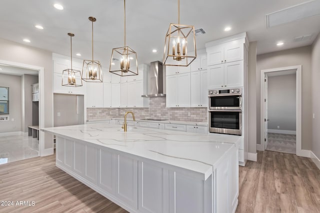 1229 N 106th Pl, Mesa, AZ 85207 - kitchen featuring wall chimney range hood, baseboards, a chandelier, white cabinets, and recessed lighting