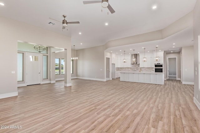 1229 N 106th Pl, Mesa, AZ 85207 - unfurnished living room with a chandelier, ceiling fan, recessed lighting, light wood-style flooring, and baseboards