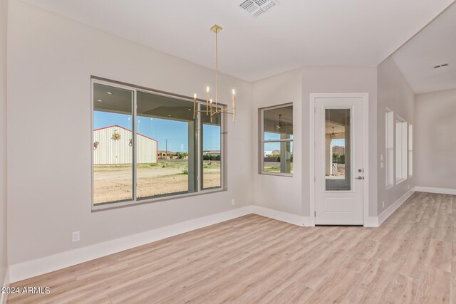 1229 N 106th Pl, Mesa, AZ 85207 - unfurnished room featuring wood finished floors, a chandelier, and baseboards