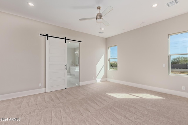 1229 N 106th Pl, Mesa, AZ 85207 - unfurnished bedroom with carpet flooring, a barn door, multiple windows, recessed lighting, and baseboards