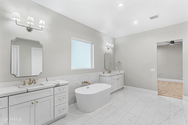 1229 N 106th Pl, Mesa, AZ 85207 - full bathroom with marble look tiles, two vanities, a soaking tub, ceiling fan, and recessed lighting
