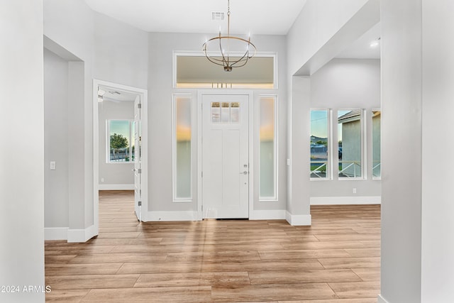 1229 N 106th Pl, Mesa, AZ 85207 - foyer entrance featuring a chandelier, light wood-style flooring, and baseboards