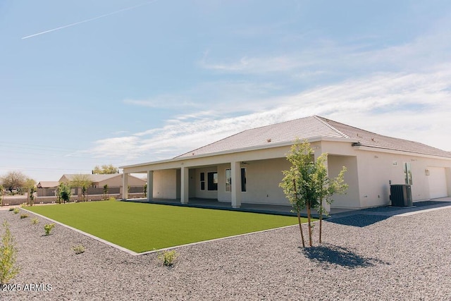 1229 N 106th Pl, Mesa, AZ 85207 - back of house featuring central AC, stucco siding, a patio area, a garage, and a tile roof